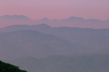 Landscape multitude of mountains interspersed evening sky in winter.の写真素材