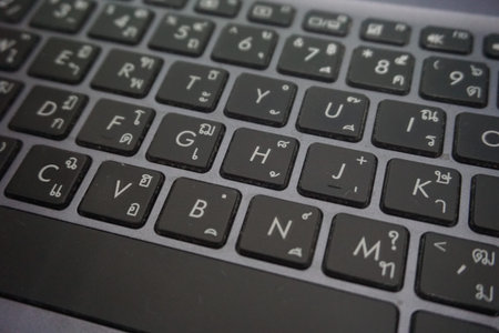 Thai and English characters on the keyboard.