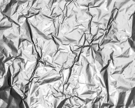 silver leaf foil background with shiny crumpled uneven surface for texture and backgroundの写真素材