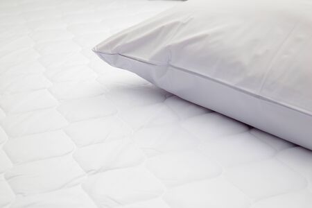 Closeup of white pillow on the bed in the bedroomの写真素材