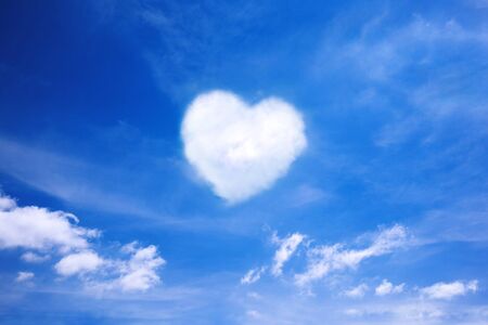 White cloud in the shape of a heart in the blue sky. Natural shape heart in the sky with clouds. Heart shaped cloud over blue sky.の写真素材