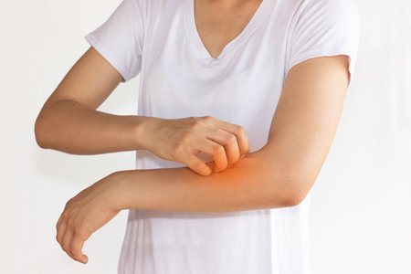 Women scratch itchy arm with hand.の写真素材