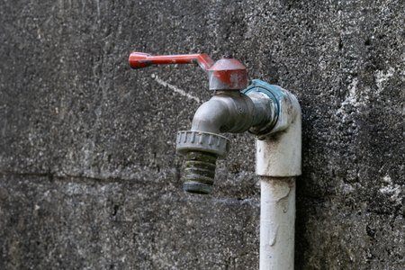 The water tap and cement wall.の写真素材