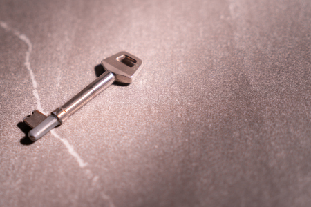 Photo of a key and stone background.の写真素材