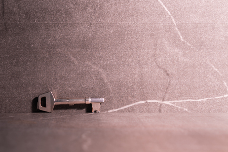 Photo of a key and stone background.の写真素材