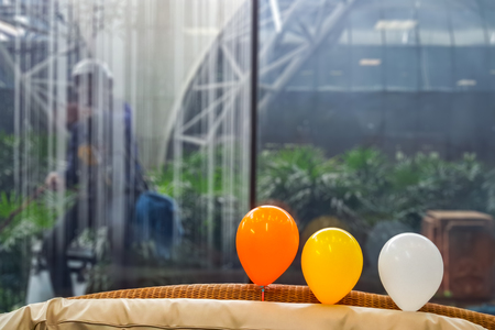 Photo of three balloon in front of glass with glass cleaner behindの写真素材