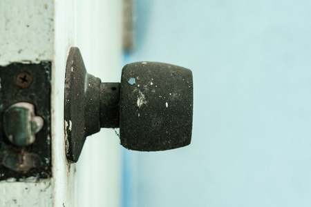 Photo of rusty knob on wooden door.の写真素材