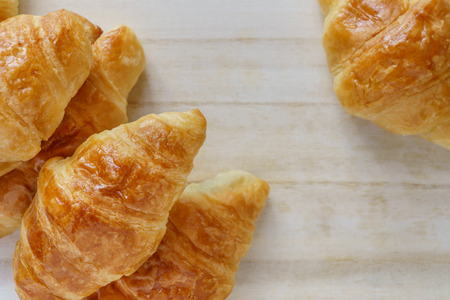Croissant on a wooden trayの写真素材