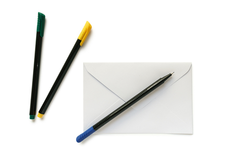 White letter envelope and pens isolated on white backgroundの写真素材