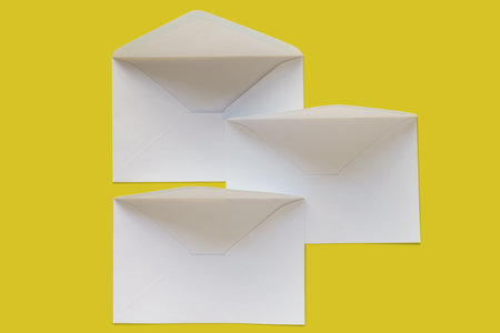 Three letter envelopes isolated on yellow background