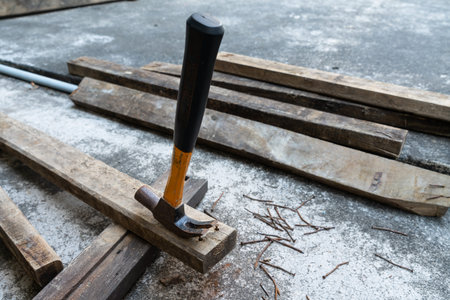 Photo of Hammer, rusty nail and wood for carpenter's job