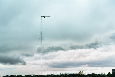 Television antennas rise into the evening sky