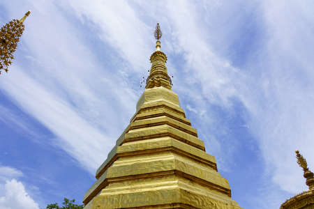 The top of the pagoda at Wat Phrathatchohae with blue sky background in Phrae province, Thailandの写真素材