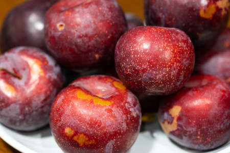 A pile of plums in a plateの写真素材