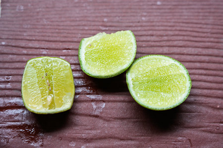 A lime sliced into three pieces on the tableの写真素材