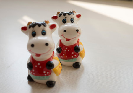 Ceramic cow figurines on a white background. Copy space.の写真素材