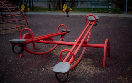 Children's playground in the city park. Children's swing on the street.