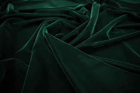 Dark green velvet fabric texture background.の写真素材