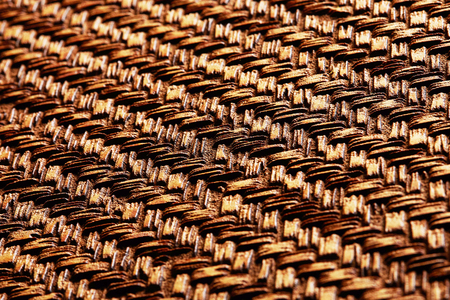 Gold bronze metal surface with abstract pattern texture background. Looks like wicker basket. Angle view.の写真素材