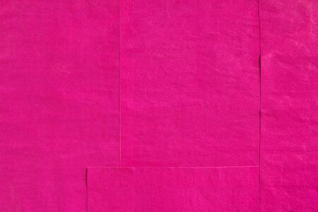 Pink or purple gloss wavy paper posters glued on billboard with rough surface texture background.の写真素材