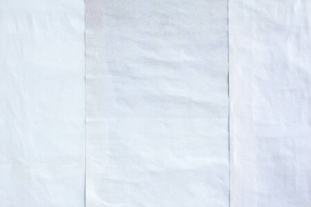 White crumpled wavy peeling paper posters glued on street billboard with rough surface texture background.の写真素材