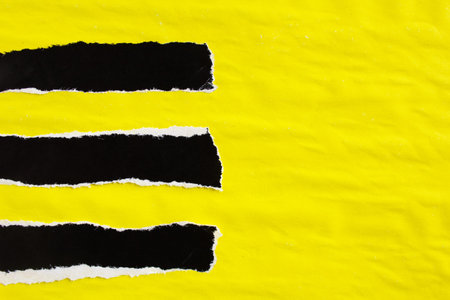 Yellow and black crumpled and ripped gloss paper posters with rough surface. Can be used for text.の写真素材