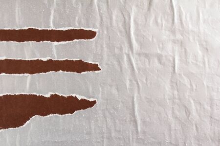 Silver grey and brown crumpled and torn shabby gloss paper posters or placards texture background. Can be used for text.の写真素材