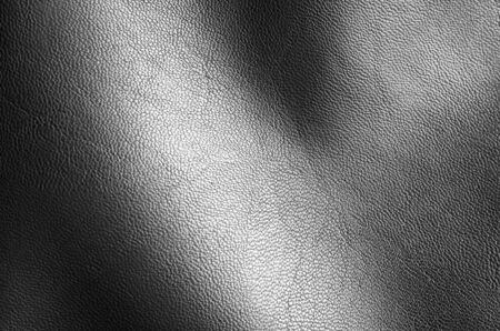 Black eco leather texture background. Dark grey artificial synthetic leather with reflection.の写真素材