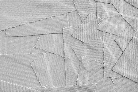 Closeup torn pieces of  grey matte cloth gaffer tape texture background.