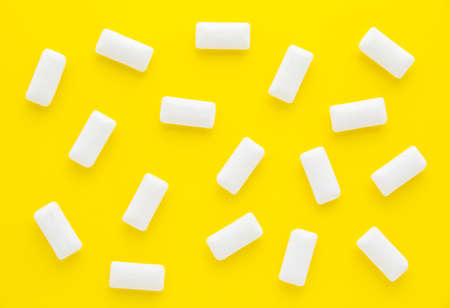 Pads of white chewing gum on yellow background. Fresh mint bubble gum.の写真素材