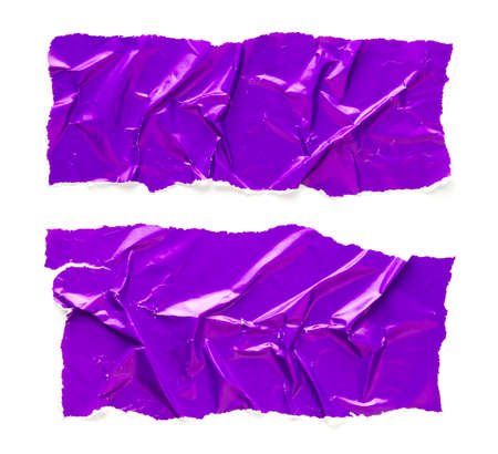 Torn and crumpled pieces of purple glossy magazine paper isolated on white background. Ripped and creased purple paper. Copy space for text.の写真素材