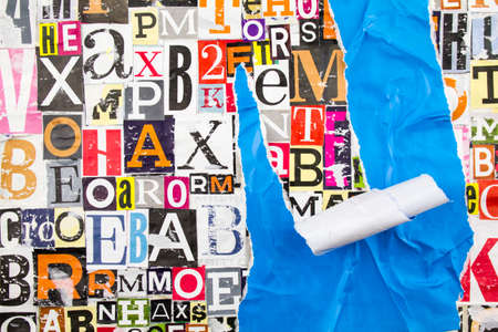Colorful collage from clippings with letters and numbers and torn crumpled piece of blue paper. Abstract creative background.の写真素材