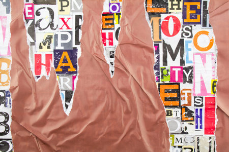 Torn and crumpled brown paper on colorful collage from clippings with letters and numbers...
