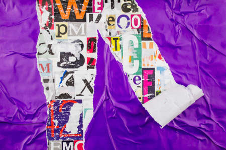 Torn and peeling purple paper on colorful collage from clippings with letters and numbers texture background.の写真素材