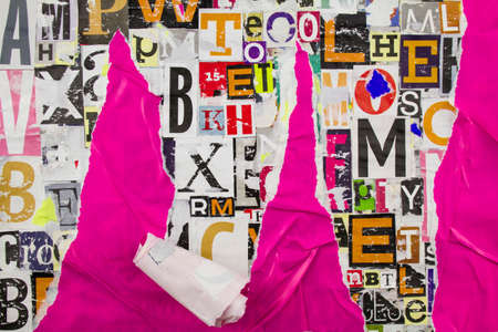 Torn, crumpled and peeling purple pink paper on collage from clippings with letters and numbers.の写真素材