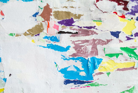 Torn crumpled and peeling pieces of old paper layers on billboard texture background.の写真素材
