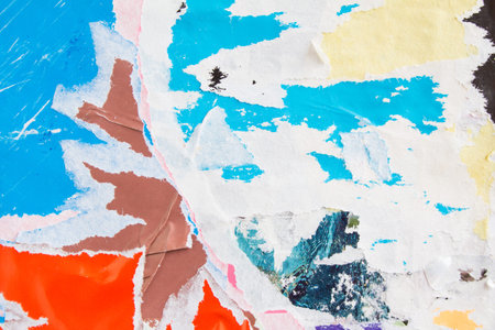 Blue, red and yellow torn shabby and crumpled old dirty paper texture background.