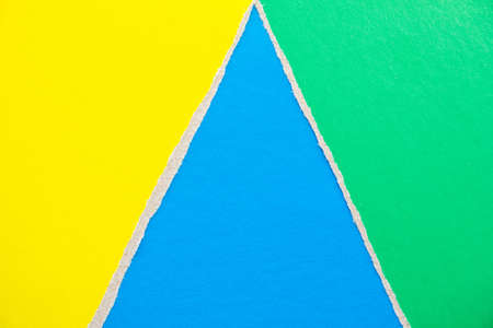Blue, green and yellow torn and ripped pieces of cardboard paper texture background. Copy space for text message.の写真素材