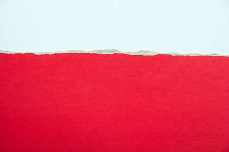 Red torn piece of cardboard paper with rough surface on white background. Copy space for text message.の写真素材