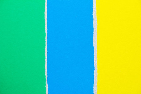 Blue, green and yellow ripped pieces of cardboard paper texture background. Copy space for text message.の写真素材