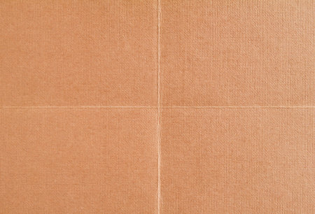 Brown blank sheet of drawing paper folded in four. Brown crumpled paper with rough surface texture...