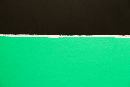 Black and green torn sheet of cardboard paper texture background. Can be used for text.の写真素材