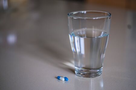 Close up shot of pills glass of waterの写真素材