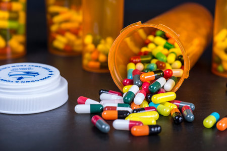 Close up of colorful pill capsules in amber plastic bottles