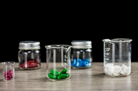 Colorful prescription pills inside different containers close upの写真素材