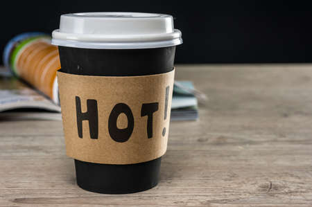 Close up shot of a blank magazine next to a takeout coffee cupの写真素材