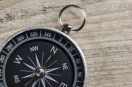 Close up of a vintage compass on woodの写真素材