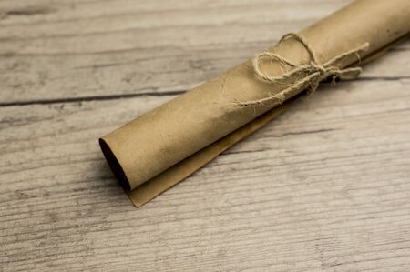 Close up shot of a vintage scroll of paper on woodの写真素材
