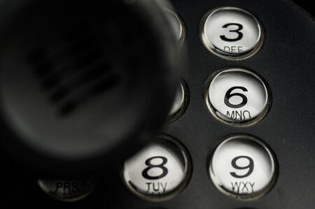 Close up shot of telephone device at office desk for customer service support conceptの写真素材