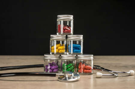 Prescription pills of various colors stacked in pyramid formationの写真素材